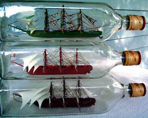 One Dollar Ship and Two White Sail Ships-in-Bottles