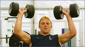 Lewis Moody pumps iron in the gym