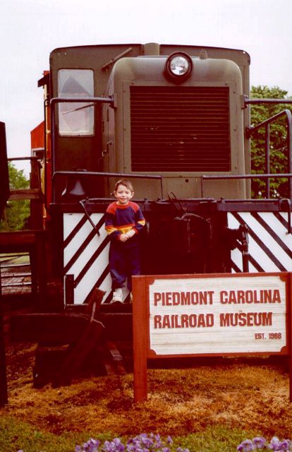[Joshua in front of the Piedmont Carolina Railroad Museum - Spring 2000]