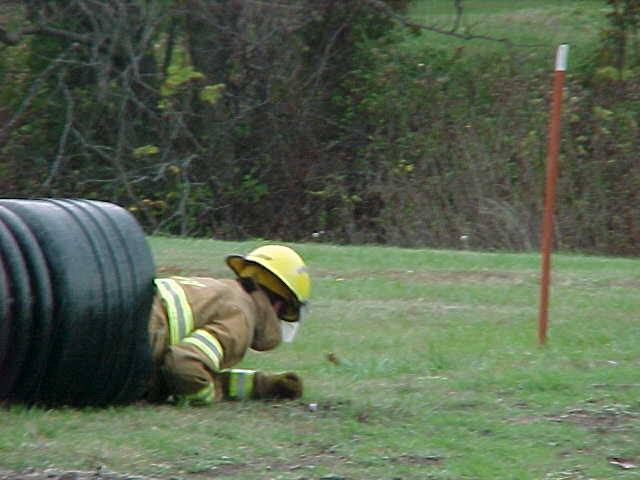 [Firefighter running Obstacle Course]