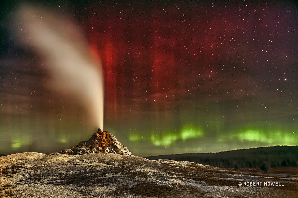 Aurora Over White Dome Geyser 

Image Credit & Copyright: Robert Howell 

Explanation: Sometimes both heaven and Earth erupt. Colorful aurorae erupted unexpectedly earlier this month, with green aurora appearing near the horizon and brilliant bands of red aurora blooming high overhead. A bright Moon lit the foreground of this picturesque scene, while familiar stars could be seen far in the distance. With planning, the careful astrophotographer shot this image mosaic in the field of White Dome Geyser in Yellowstone National Park in the western USA. Sure enough, just after midnight, White Dome erupted -- spraying a stream of water and vapor many meters into the air. Geyser water is heated to steam by scalding magma several kilometers below, and rises through rock cracks to the surface. About half of all known geysers occur in Yellowstone National Park. Although the geomagnetic storm that created these aurorae has since subsided, eruptions of White Dome Geyser continue about every 30 minutes. 