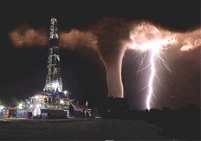 THIS IS A PICTURE THAT SOMEONE TOOK WHO WORKS ON AN OIL RIG.  HE WAS GOING TO TAKE A PICTURE OF THE LIGHTNING AND WAS  UNAWARE OF THE TORNADO UNTIL THE LIGHTNING ILLUMINATED IT. 