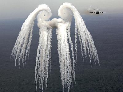 It is not a naturally occurring one. Looking perhaps a bit like a gigantic owl monster, the cloud pictured above resulted from a series of flares released by an air force jet over the Atlantic Ocean in May. The jet that released the flares, a C-17 Globemaster III, is seen on the right. The flares release smoke and the resulting pattern is sometimes known as a smoke angel. The circular eyes of the above smoke angel are caused by air spiraling off the plane's wings and are known as wingtip vortices.