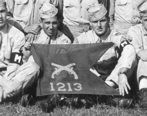 Closeup of unit members holding unit flag
