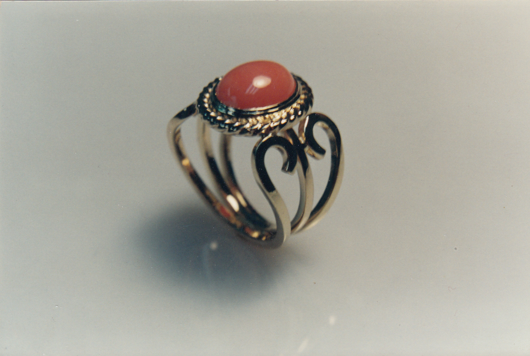 All hand wrought wire work ring with a bezel set Coral cabochon.