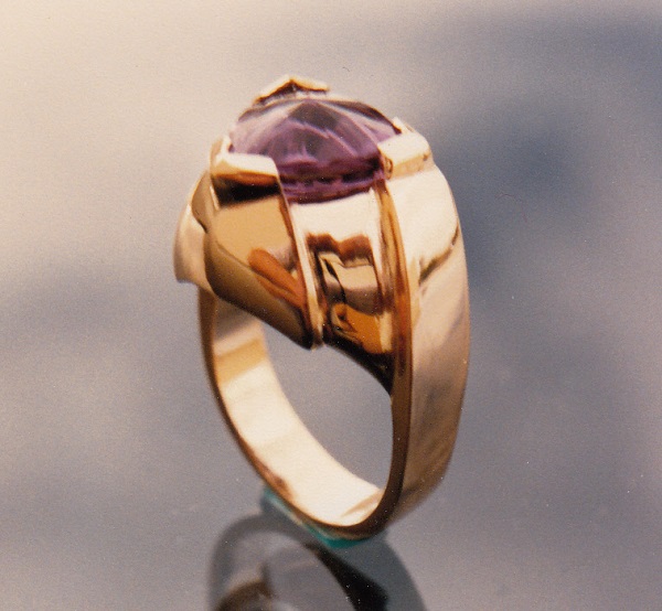 Incredible fantasy cut amethyst set in exclusive hand carved gold mounting.
