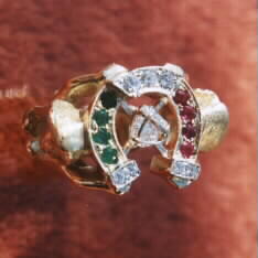 Finished horseshoe ring with beautiful colorful gemstones. Diamonds, rubies and emeralds.