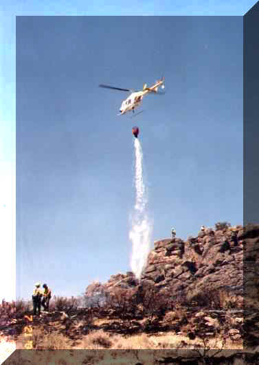 Helicopter 85-Alpha doing bucket work on the Mud Springs Fire near Midas, NV in July 2001.  Higher resolution picture found on 2001-2002 Fire Season Picture Page.