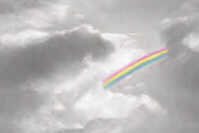 a rainbow in dark clouds