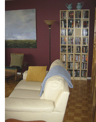Where you're standing in the second pic, do a 180 to look at the south end of the living room. Bookshelves on the right; DVDs at the end. The Vincent looks so much smaller in this room. I look at it less often now but when I do, it's with pleasure, not from need—the sky is right outside my windows. This an end unit. There's no one beyond that wall and no bedrooms near this room, above or below, so it's a great music room.