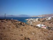 The windmills of Mykonos town in the distance.