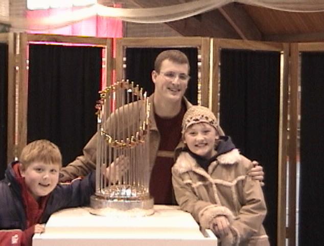 Mike, Emma, and Preston admiring the Boston Red Sox World Series trophy at Williams College