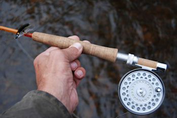 Holding Rod, Reel, and Fly