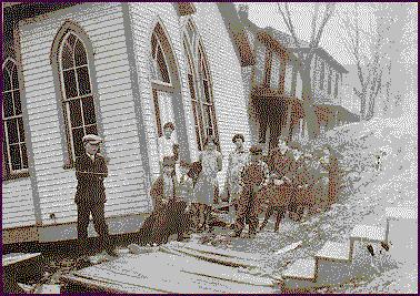 kids in front of damaged church