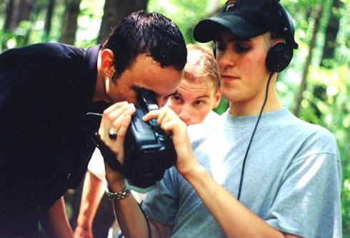 [Director Erik Woods checks the footage with Aaron Vollick and Rob Peace.]