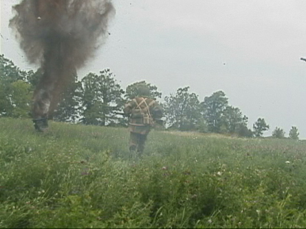 [Carrington (Al) runs from the explosions.]