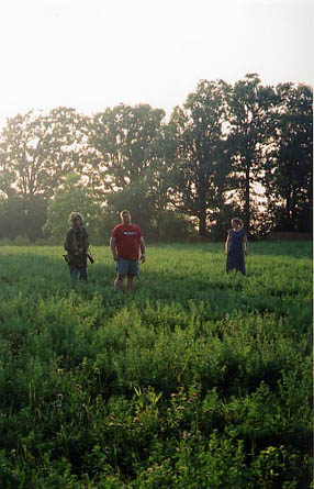 Tim Sullivan sets up the shot with Brent Woods and Alicia Stanton standing in the farmers field.
