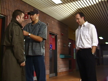 [Director Erik Woods sets up the shot with Scott Harris and Kris Nichols]