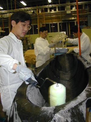 rolling resin into the carbon mat