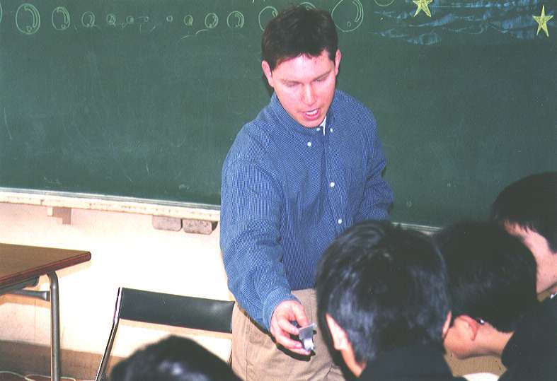 Showing an automobile piston to the students