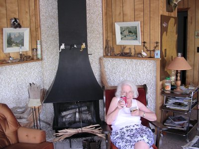 Grandma has a beer in the cottage