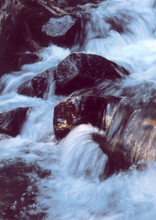 Freezing cold water flows over some rocks near Black Lake