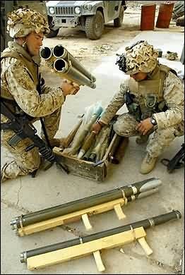 Marines examine homemade Iraqi multi-barrel rocket weapons