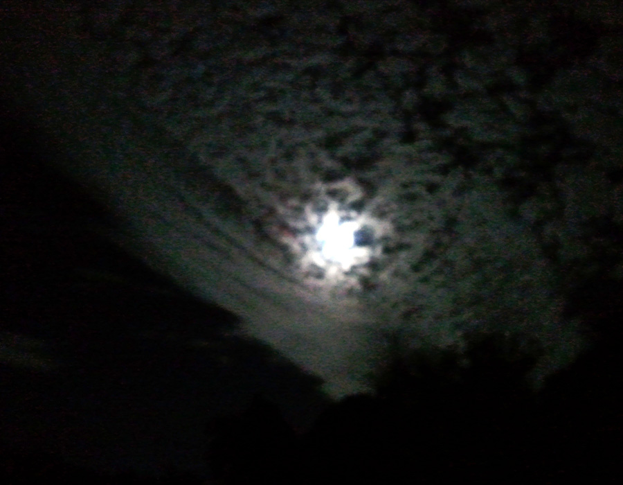 Big noon peeking through the night clouds