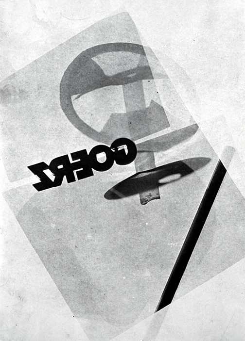 a flattened image of a circle, cut
across with lines that become transparent as
they leave an 'edge' of the picture plane.
Half-backward, upside down the word 'GOERZ'
mysteriously stenciled across it.