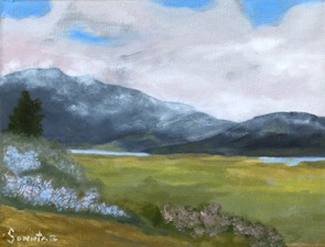 Painting of a Green Field and Bushes with Mountains in the Background Partially Covered by Clouds