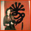 Tania w/AK47 machine gun & Symbionese flag background