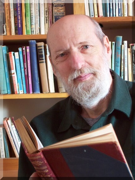 An image of the company's founder, James Davis, reading a book in his library, looking into the camera.