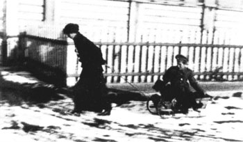 One of the sisters pulling Alexei on a sled