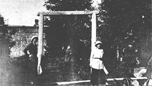 Alexei playing on a swing with his sisters and father watching