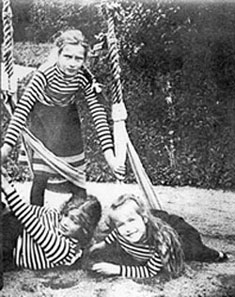 Tatiana, Maria and Anastasia playing on swings