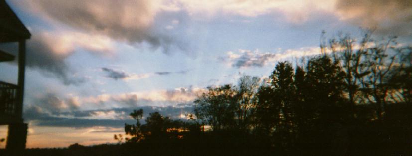 A sunset over the fall foliage.