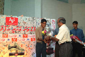 Ali-Shiham receives the Footballer trophy from FAM General Secretary Ibrahim Ismail