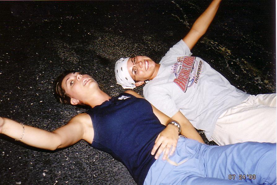 Jessica and Katie chillin on the parking lot listening to tunes and dancing with their hands.