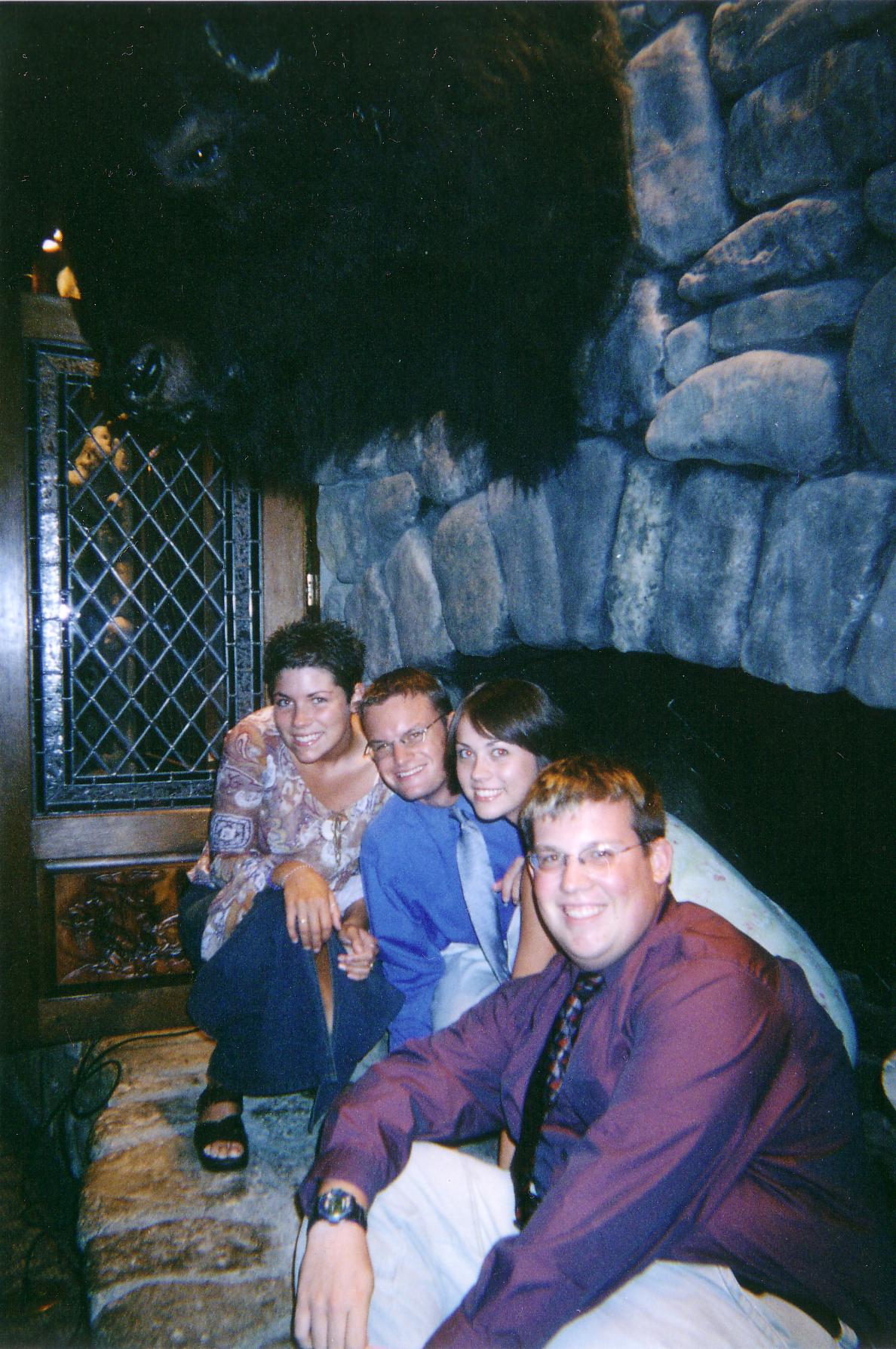 Jessica, Smithers, Katie and Ryan in a fireplace under a buffalo.