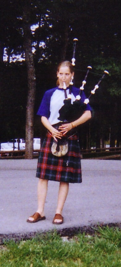 Heather playing the bagpipes at the guy's basketball game.