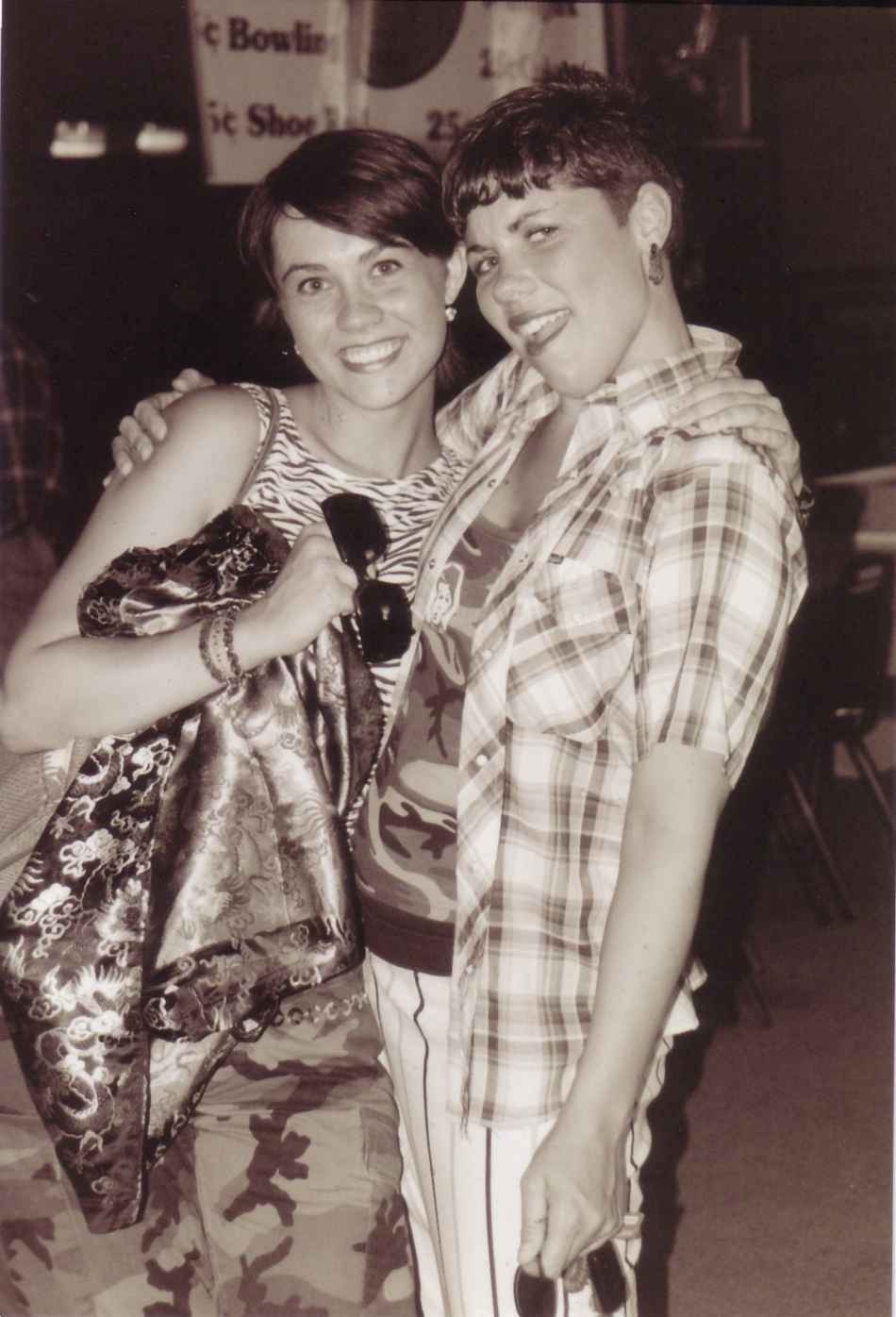 Katie and Jess grinning in the cheesy rags.