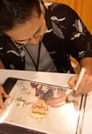 Nishimura-san takes additional time to sign this cel of Knives (previously autographed by the creator Nightow & character designer Yoshimatsu) from TRIGUN, which he also directed!