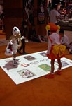 According to their mom, these kids stomping around with Geneon's interactive floor projection system are Princess Sissy and Clara from POWER INSTINCT MATRIMELEE (a NeoGeo game)