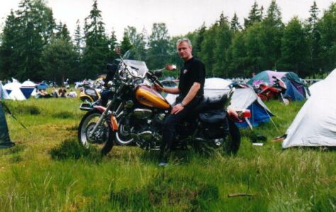 Krister proudly standing by his motorcycle