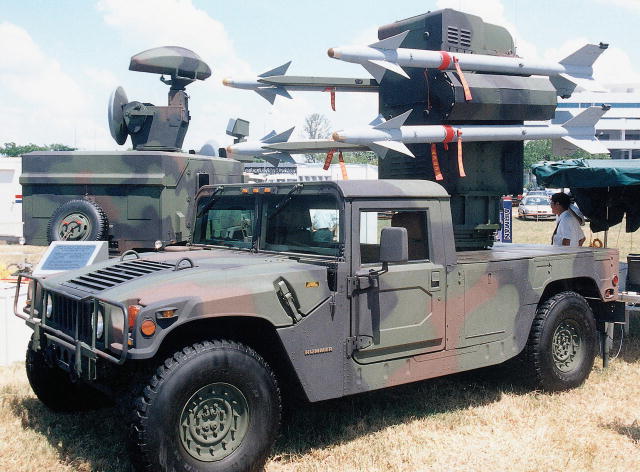 The Antelope low-level air defence system has search and track radars (left background) and four Sky Sword 1 missiles mounted on an HMMWV (foreground) with a FLIR (Paul Jackson). (68,307 bytes)