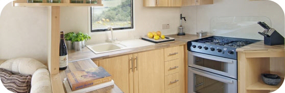 Kitchen, This food preparation area is very clever in it's design. The Sink and cooker are ingeniously moved to the side allowing room for people traffic through the caravan. An unbeleivable amount of over in and under storage cupbords. All appliances are in the tradtional triangle design. includes Microwave, Kettle, Toaster and all the essential Pots, Pans, Glasses, Cuttlery, knives, & Salad Bowls. Black Granite Worktop now fitted. FULLY EQUIPPED.