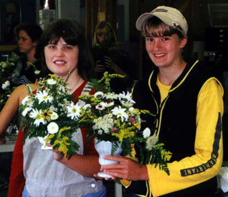 [students with their floral arrangements]