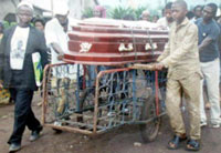 Dahuanja's remains being wheeled to final abode by father and kid brother. 