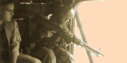 navy corpsman ned creed and crewchief/gunner d v cooper coming into a hot landing zone.  creed was killed in action several months after this photo was taken