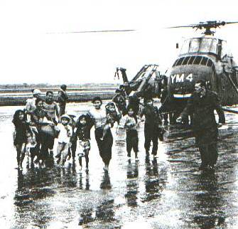 pfc schuldheisz leads vietnamese flood refugees to shelter